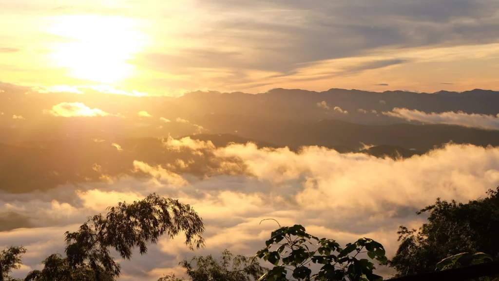 The image shows the view of the valley at sunset from Doi Luang Chiang Dao
