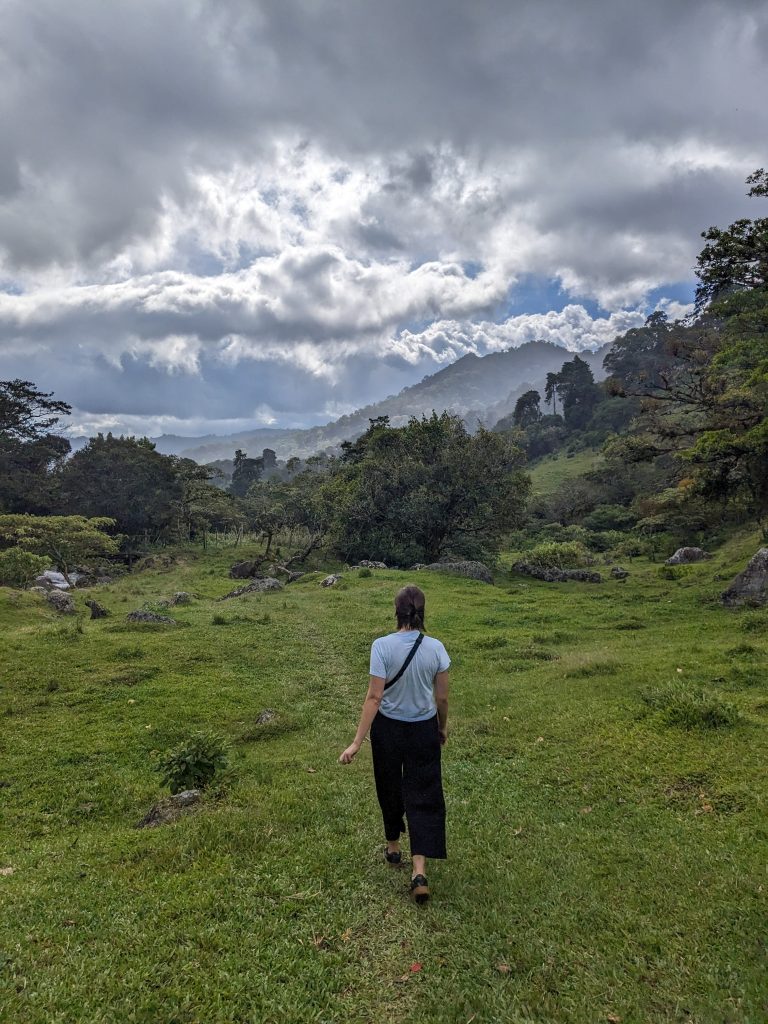 Scenic valley views near the start of the El Pianista Hiking trail in Boquete, Panama, with rolling green hills and a stunning mountains 