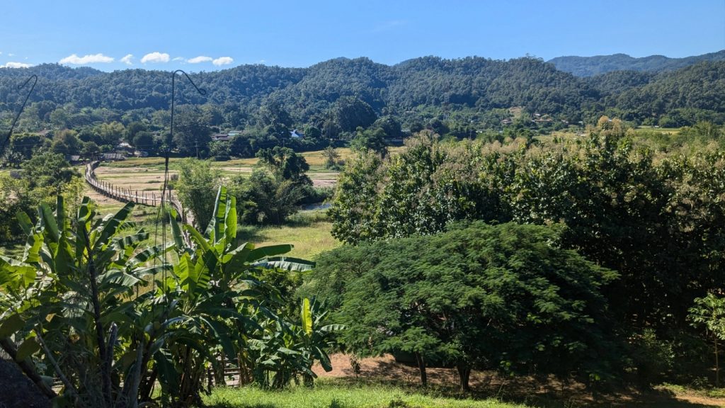 View of Su Tong Pae bridge winding through rice fields