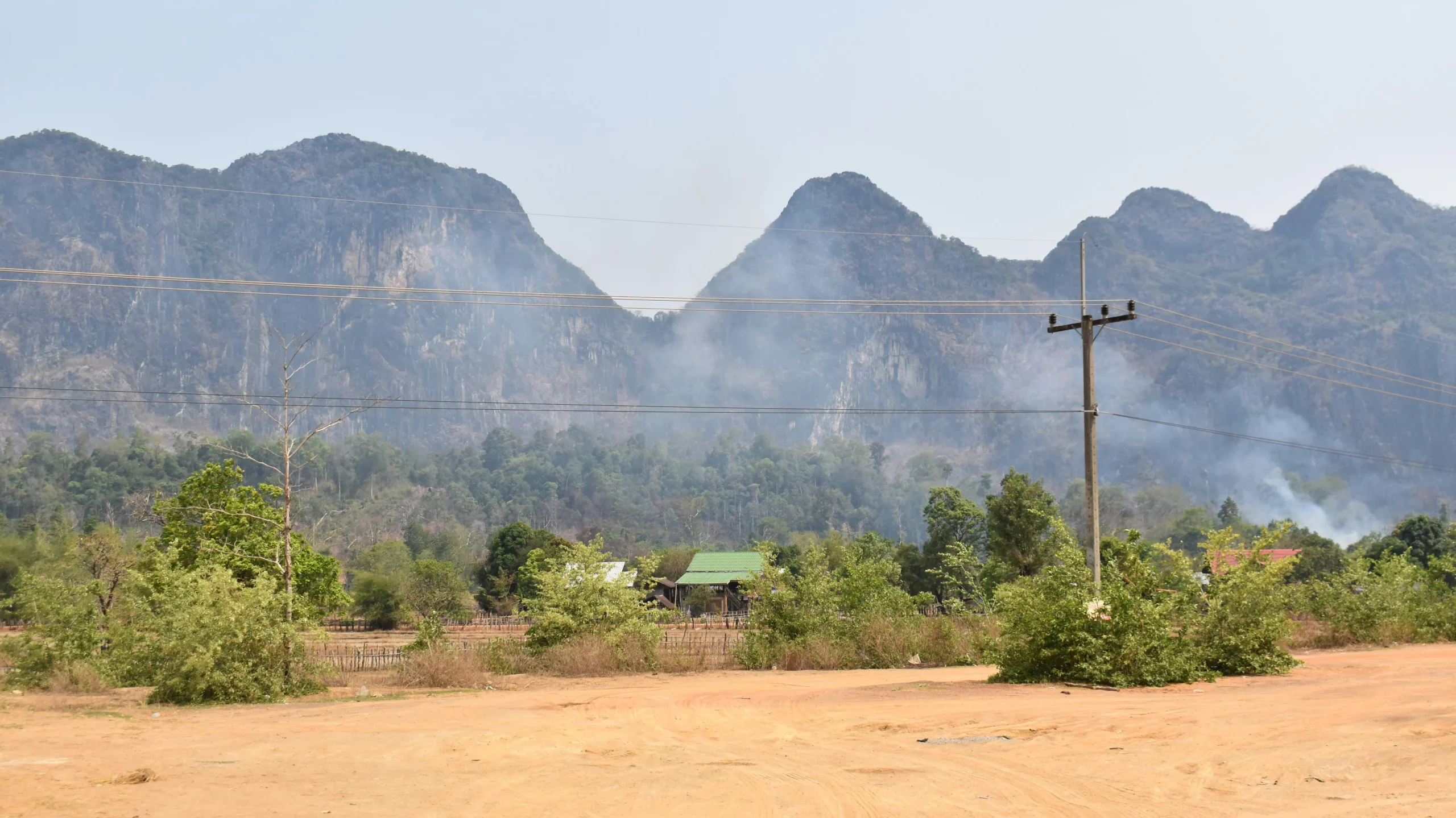 Smoke drifting through the air in front of mountains