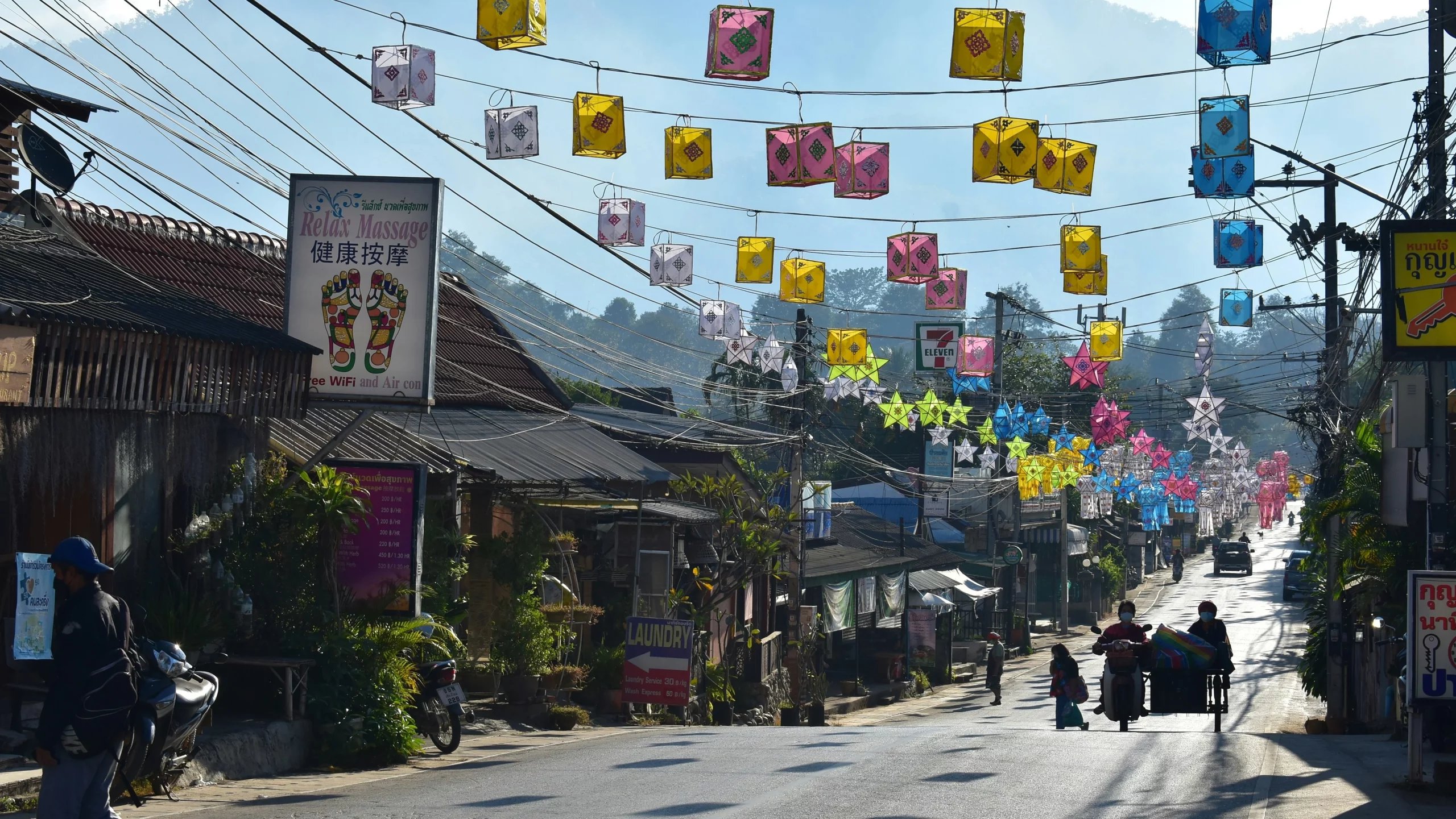 The main street in Pai during the day decorated with colouful lanterns