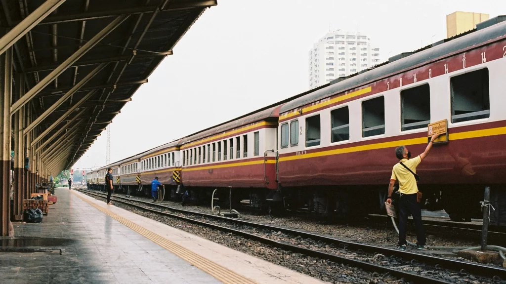 Auburn coloured sleeper train in Bangkok on a cloudy day